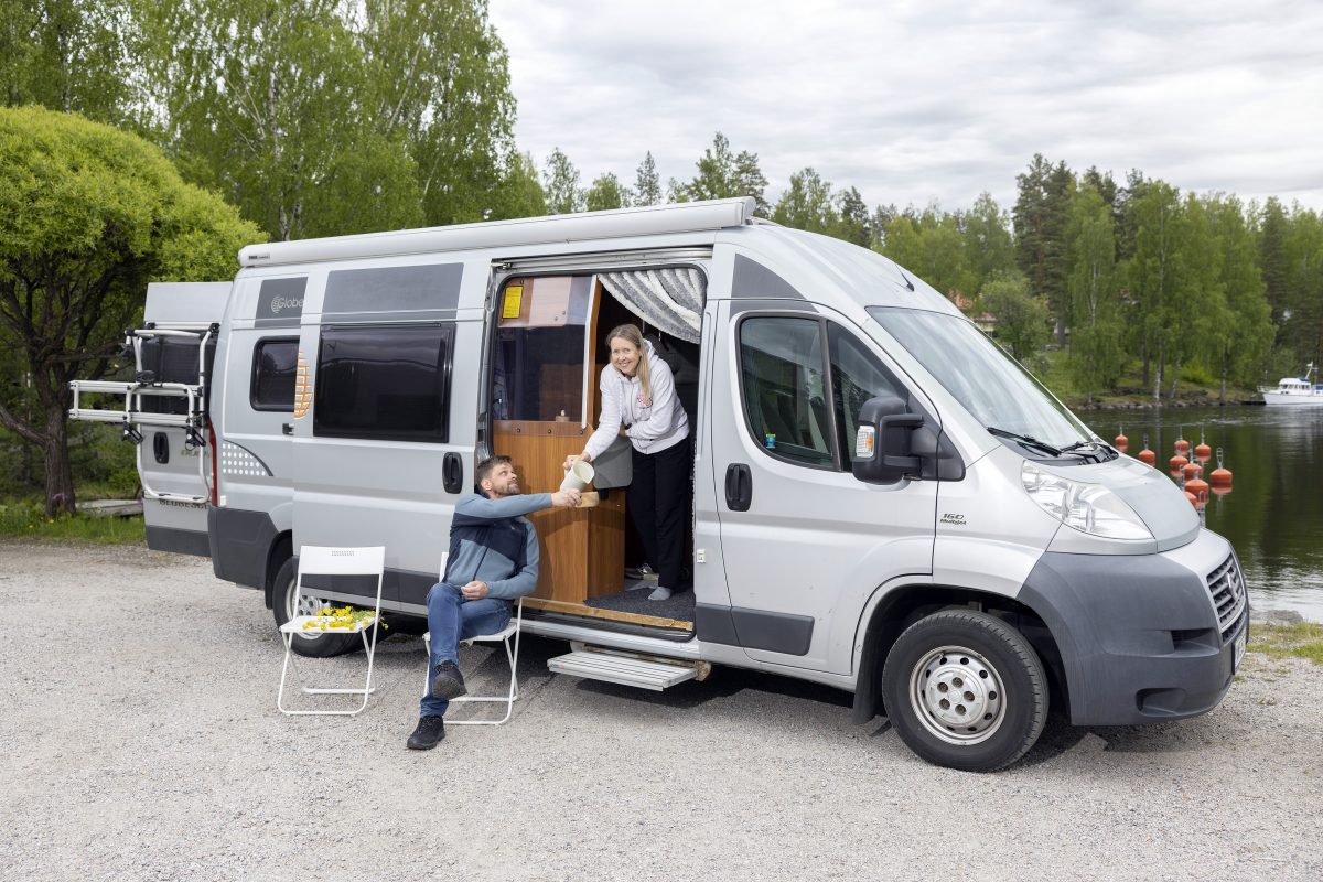 Miia ja Vesa Moisio viettävät aikaa retkeilyautonsa luona.